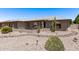 Charming single-story home featuring desert landscaping, gray brick accents and covered front entry at 7904 E Madero Ave, Mesa, AZ 85209