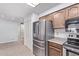Modern kitchen with stainless steel appliances, tile flooring, and ample cabinet space at 7904 E Madero Ave, Mesa, AZ 85209