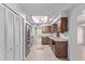 A spacious kitchen featuring stainless appliances, wood cabinetry, and tile floors at 7904 E Madero Ave, Mesa, AZ 85209