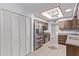 Kitchen boasts stainless steel appliances, wood cabinets, and tile flooring at 7904 E Madero Ave, Mesa, AZ 85209