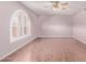 Bright living room with laminate flooring, a large window with shutters, and a ceiling fan at 7904 E Madero Ave, Mesa, AZ 85209