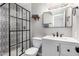 Modern bathroom featuring a stylish black-framed glass shower and updated vanity at 7915 E Keim Dr, Scottsdale, AZ 85250