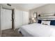 Well-lit bedroom with a sliding closet door and a whitewashed headboard at 7915 E Keim Dr, Scottsdale, AZ 85250