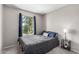 Cozy bedroom features a large window with a tree view and light-colored walls at 7915 E Keim Dr, Scottsdale, AZ 85250