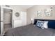 Bedroom with gray comforter, white dresser, and a doorway to another room at 7915 E Keim Dr, Scottsdale, AZ 85250