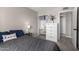 Bedroom featuring closet, desk, dresser, and gray comforter on the bed at 7915 E Keim Dr, Scottsdale, AZ 85250
