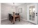 Cozy dining room with a wooden table, chandelier, and access to the backyard at 7915 E Keim Dr, Scottsdale, AZ 85250