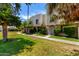 Exterior shot of a two-story townhouse showcasing the surrounding greenery at 7915 E Keim Dr, Scottsdale, AZ 85250