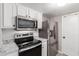 Modern kitchen with stainless steel appliances and white cabinets at 7915 E Keim Dr, Scottsdale, AZ 85250
