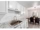 Modern kitchen featuring white cabinetry and stainless steel appliances with bar seating at 7915 E Keim Dr, Scottsdale, AZ 85250