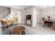 Open-concept living space with a television, dining area, and stairs to a second level at 7915 E Keim Dr, Scottsdale, AZ 85250