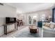 Bright living room with a modern rug, gray sofa, and glass patio doors at 7915 E Keim Dr, Scottsdale, AZ 85250