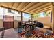 Inviting covered patio area with a bar-height table, chairs, and colorful outdoor rug at 7915 E Keim Dr, Scottsdale, AZ 85250