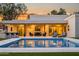Outdoor living area boasts a pool, patio seating, and modern outdoor design elements at sunset at 8501 E Appaloosa Trl, Scottsdale, AZ 85258