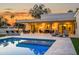 Inviting backyard pool with travertine decking, outdoor kitchen, and comfortable lounge area perfect for entertaining at 8501 E Appaloosa Trl, Scottsdale, AZ 85258