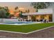 Backyard oasis features a sparkling pool, outdoor kitchen, and lounge areas with bar seating at 8501 E Appaloosa Trl, Scottsdale, AZ 85258