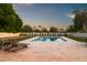 Inviting backyard showcases a pool, stone patio, and comfortable lounge chairs in a serene setting at 8501 E Appaloosa Trl, Scottsdale, AZ 85258