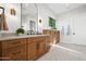 Bathroom featuring marble floors, a wooden vanity with a white countertop, and decorative sconces at 8501 E Appaloosa Trl, Scottsdale, AZ 85258