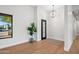 Bright entryway with hardwood floors, stylish light fixture, and a view to the outside at 8501 E Appaloosa Trl, Scottsdale, AZ 85258