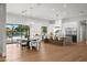 Modern kitchen with hardwood floors, white cabinets, stainless steel appliances, and a large kitchen island at 8501 E Appaloosa Trl, Scottsdale, AZ 85258