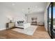 Spacious main bedroom featuring hardwood floors, a ceiling fan, and a sitting area near sliding glass doors at 8501 E Appaloosa Trl, Scottsdale, AZ 85258
