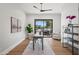 Office area with hardwood floors, a ceiling fan, a desk, and access to the backyard patio at 8501 E Appaloosa Trl, Scottsdale, AZ 85258