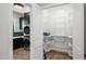 Pantry and Laundry area featuring black cabinetry, a stackable washer/dryer, and custom shelving at 8501 E Appaloosa Trl, Scottsdale, AZ 85258