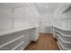 Bright walk-in closet with custom shelves, drawers, and hardwood floors at 8501 E Appaloosa Trl, Scottsdale, AZ 85258