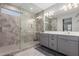 This is a view of the main bathroom, with a glass enclosed shower and double vanity at 8737 E Nichols Ave, Mesa, AZ 85209