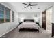 This is a view of the main bedroom with a king bed, barn door to the main bathroom and bright natural light at 8737 E Nichols Ave, Mesa, AZ 85209