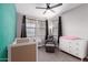 This Bedroom features a crib, dresser, and accent chair bathed in natural light at 8737 E Nichols Ave, Mesa, AZ 85209