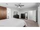 This is a bedroom with gray walls, carpeted floors and sliding barn door to main bathroom at 8737 E Nichols Ave, Mesa, AZ 85209