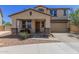 Charming two-story home featuring a covered porch, a two car garage, and low maintenance landscaping at 8737 E Nichols Ave, Mesa, AZ 85209