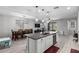 Open concept kitchen featuring an island with a sink, stainless appliances, and a view of the dining area at 8737 E Nichols Ave, Mesa, AZ 85209