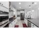 Modern kitchen featuring stainless steel appliances, gray countertops and white cabinetry at 8737 E Nichols Ave, Mesa, AZ 85209