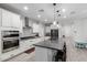 Bright and airy kitchen boasting white cabinets, a large center island, and stainless steel appliances at 8737 E Nichols Ave, Mesa, AZ 85209