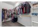 Walk-in closet has ample storage with shelving and rod racks at 8737 E Nichols Ave, Mesa, AZ 85209