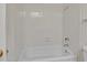 Clean and simple bathroom with a white tiled shower and tub at 8741 W Osborn Rd, Phoenix, AZ 85037