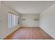 Empty bedroom featuring neutral walls, laminate floors, and a large window at 8741 W Osborn Rd, Phoenix, AZ 85037