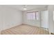 Simple bedroom featuring a window, tile flooring, and light walls at 8741 W Osborn Rd, Phoenix, AZ 85037
