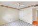 Bright bedroom with tile floors, ceiling fan, and closet at 8741 W Osborn Rd, Phoenix, AZ 85037