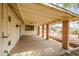 Spacious covered patio with brick pillars and ceiling fan at 8741 W Osborn Rd, Phoenix, AZ 85037