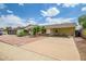 Front exterior featuring driveway, mature landscaping and carport at 8741 W Osborn Rd, Phoenix, AZ 85037