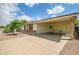 Charming single-story home featuring a covered carport and well-maintained landscaping in the front yard at 8741 W Osborn Rd, Phoenix, AZ 85037