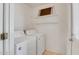 Functional laundry room with washer, dryer, and shelving at 8741 W Osborn Rd, Phoenix, AZ 85037