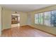Bright living room with laminate flooring and an open view into the kitchen at 8741 W Osborn Rd, Phoenix, AZ 85037