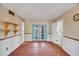 Spacious living room featuring wood floors and doors leading to outdoor space at 8741 W Osborn Rd, Phoenix, AZ 85037