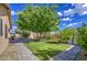 Wide backyard featuring mature trees and brick pavers, ideal for outdoor activities and entertaining at 9413 W Williams St, Tolleson, AZ 85353