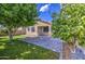 Backyard featuring green grass, trees, and a patio area, creating a relaxing outdoor space at 9413 W Williams St, Tolleson, AZ 85353