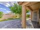 Backyard patio with brick pavers, lush green grass, and mature landscaping at 9413 W Williams St, Tolleson, AZ 85353